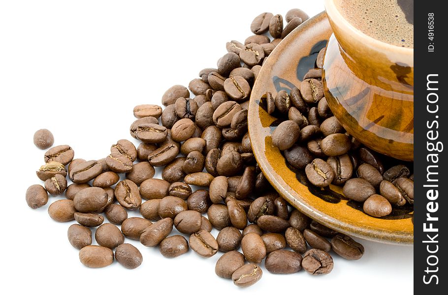 Coffee beans and black coffee in a cup isolated on a white background