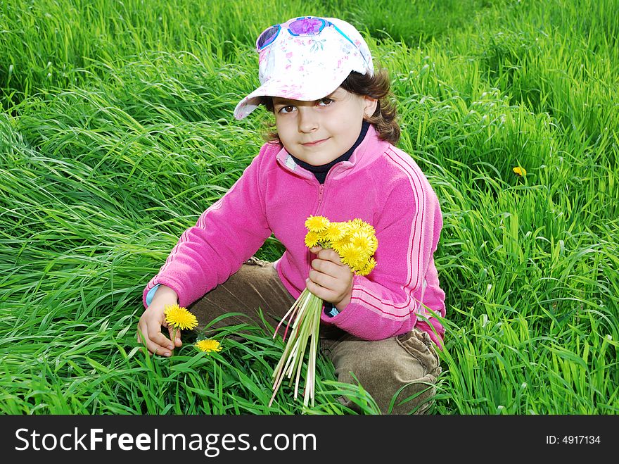 Pretty child play on fresh green grass