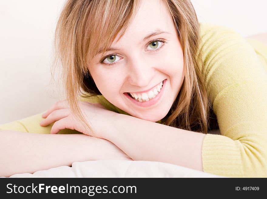 Beautiful young smiling woman relaxing at home. Beautiful young smiling woman relaxing at home