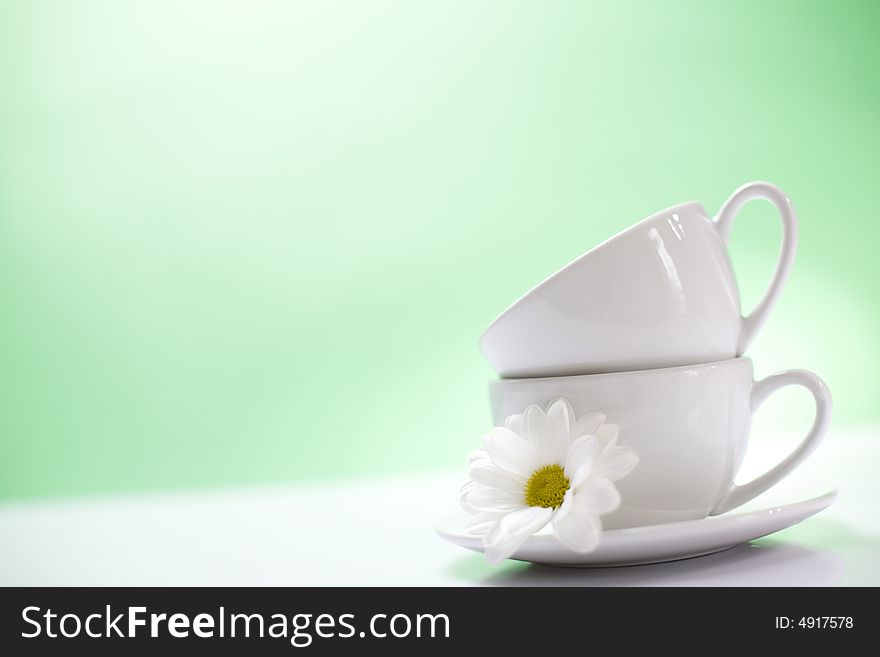 Two coffee cups on the green background / copyspace