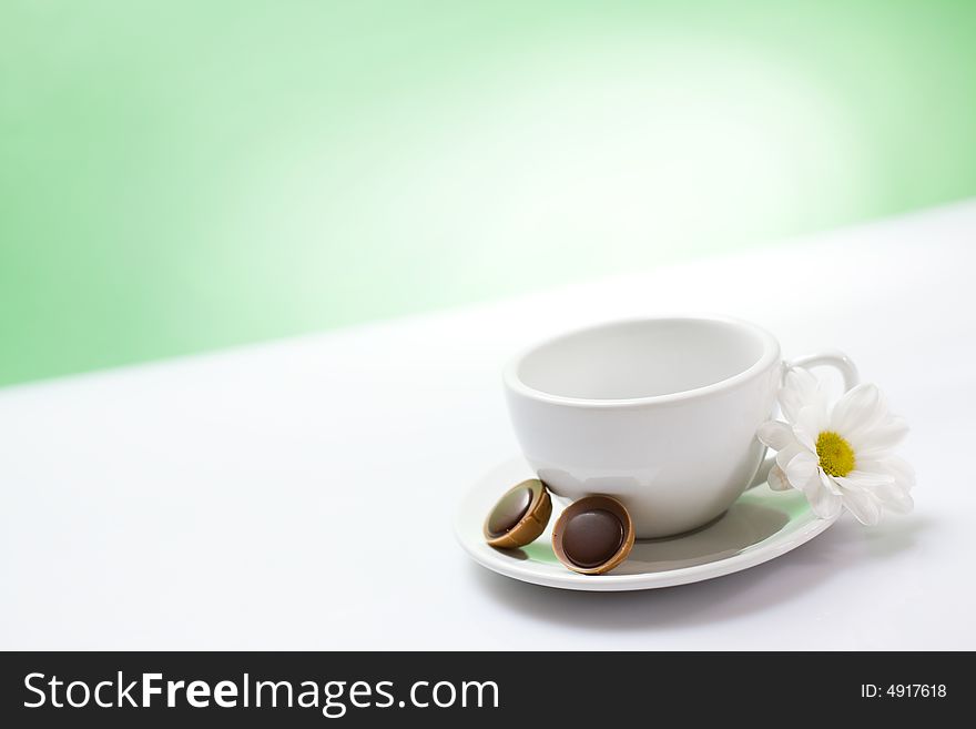 White cup on the green background / copyspace