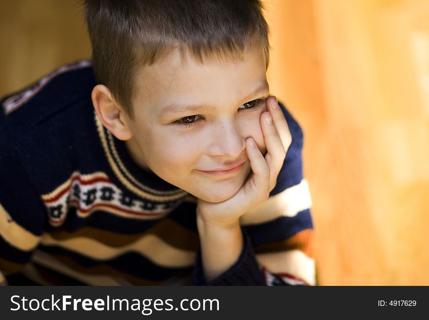 Sitting boy with smiley face on light background