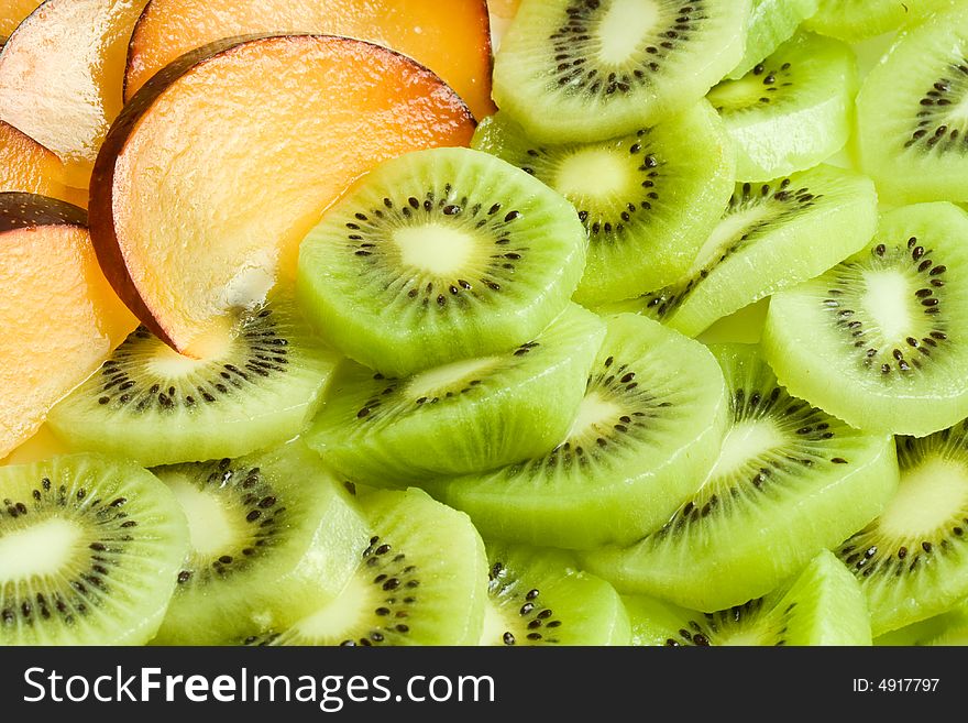 Background from sliced kiwi and plums. Background from sliced kiwi and plums.