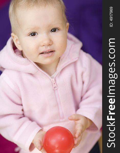 Girl with small ball on violet background