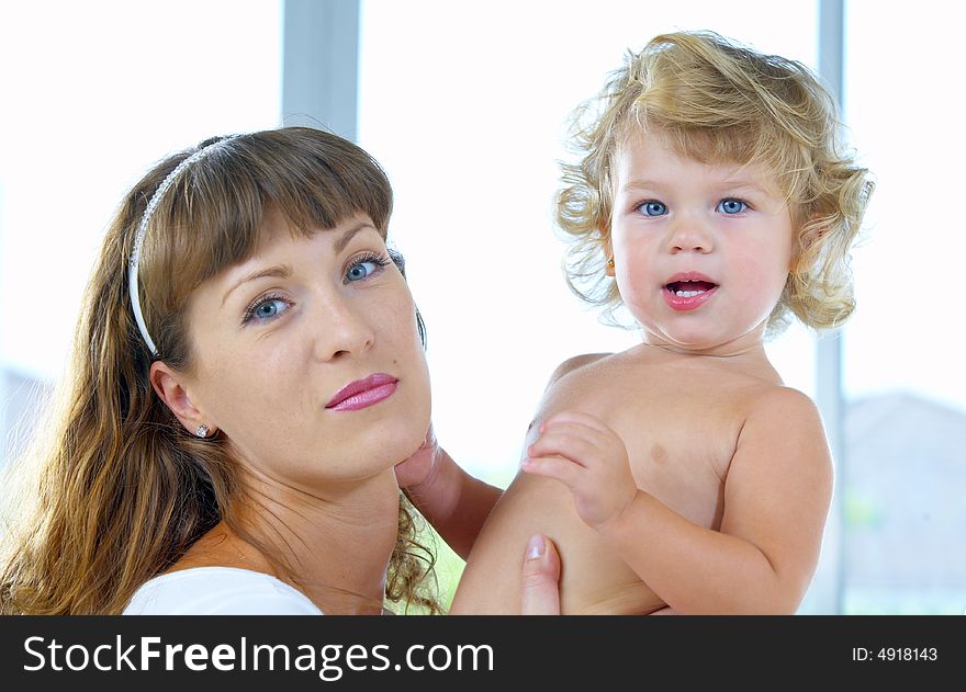 High key portrait of happy mother with baby. High key portrait of happy mother with baby