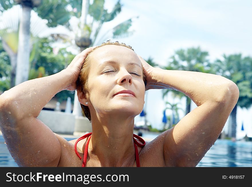 Portrait of nice young woman relaxing in swimming pool. Portrait of nice young woman relaxing in swimming pool