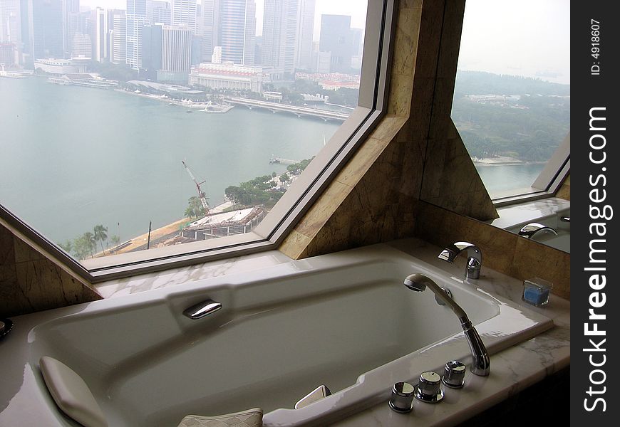 Hotel bathroom with city view. Hotel bathroom with city view