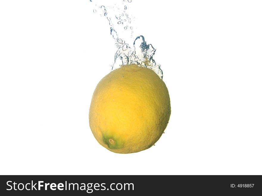 A lemon splashing in water
