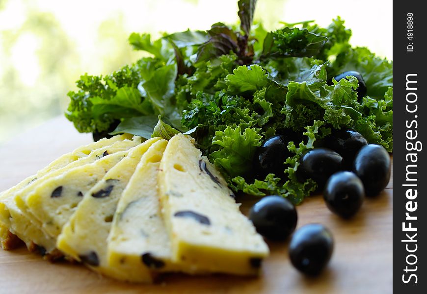 Cheese with olive and green salad