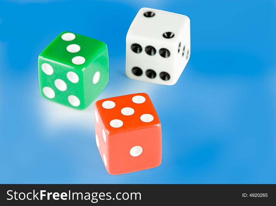 Three dice pieces on blue background