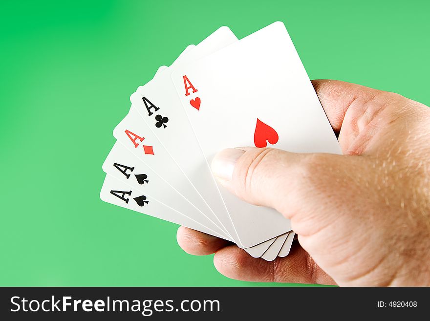 Five aces from a deck of cards held in hand