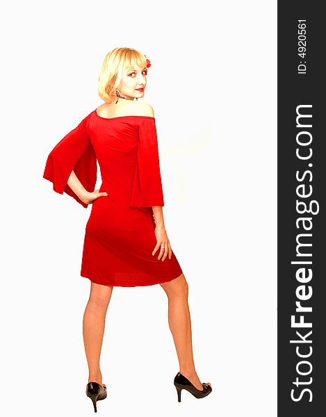 An friendly blond girl in an short red dress standing in an studio 
for white background with a red flower in her hair. An friendly blond girl in an short red dress standing in an studio 
for white background with a red flower in her hair..