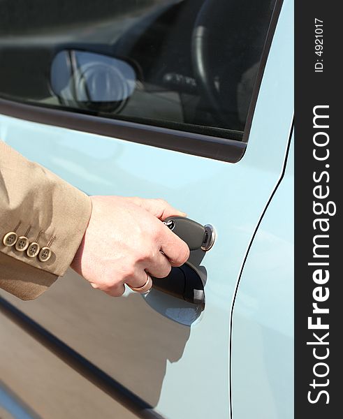 Men hand with key in jacket open car door. Men hand with key in jacket open car door