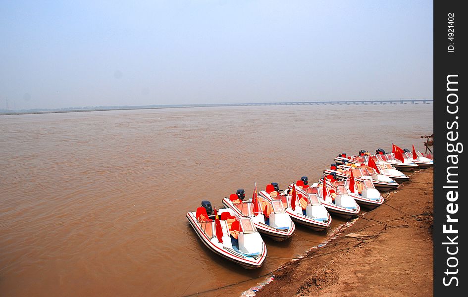 A file of motoboats by the Yellow River,central China,Henan,provinc. A file of motoboats by the Yellow River,central China,Henan,provinc.