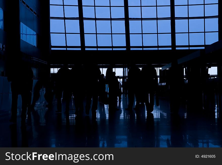 Black silhouettes of people in business center