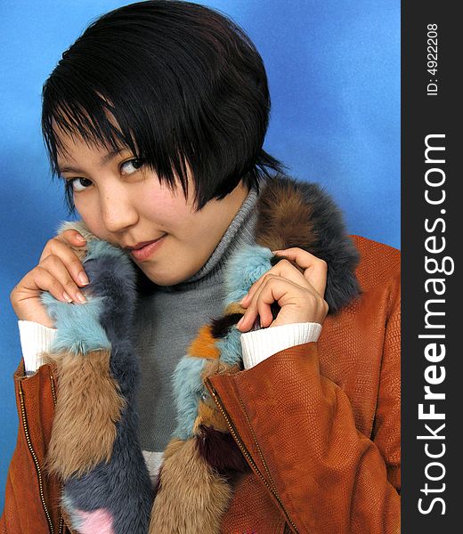 The girl in furs on blue background