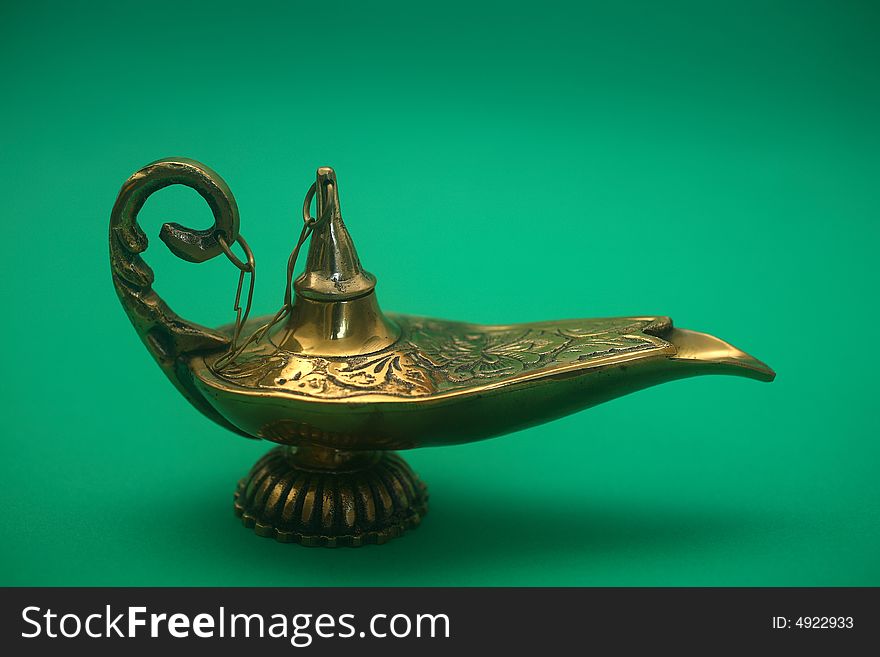 An isolated golden or bronze magic genie lamp, like Aladdins! :)