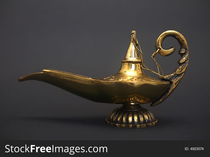 An isolated golden or bronze magic genie lamp, like Aladdin's! :)