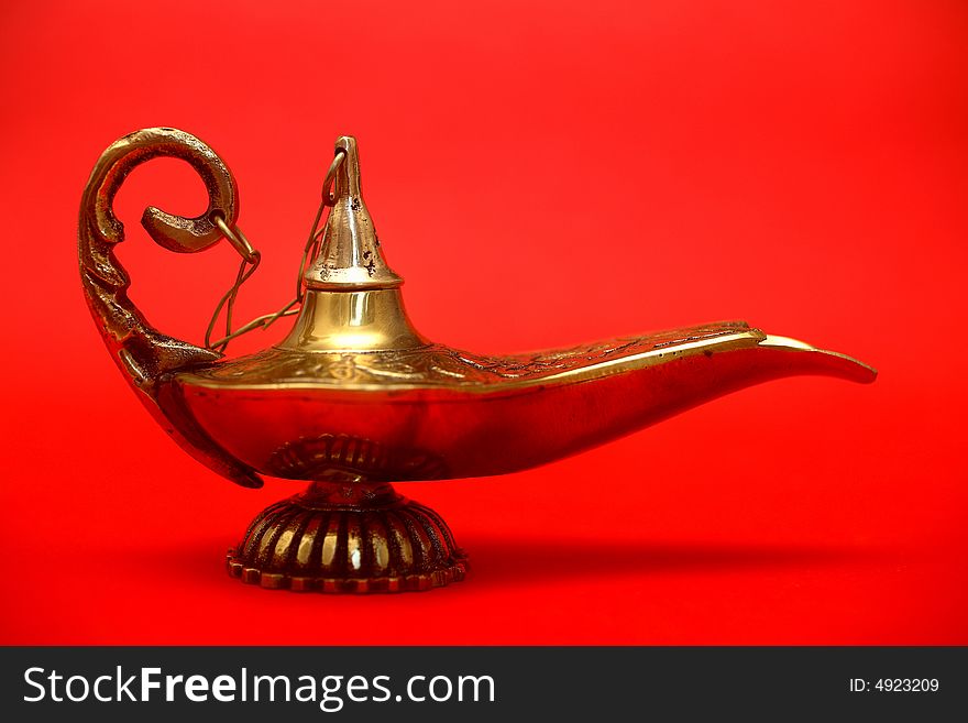 An isolated golden or bronze magic genie lamp, like Aladdin's! :)