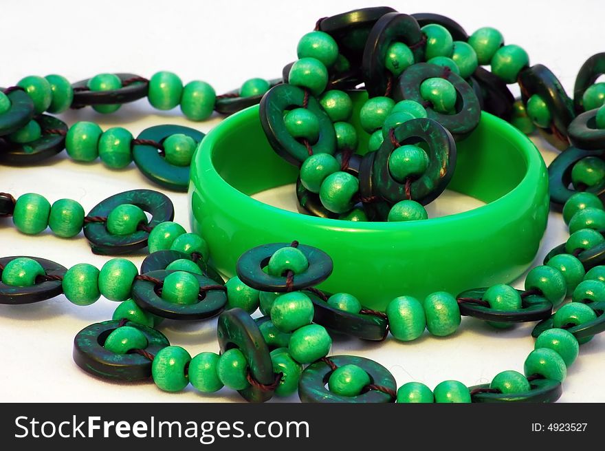 Green plastic bracelet and beads isolated on the white background