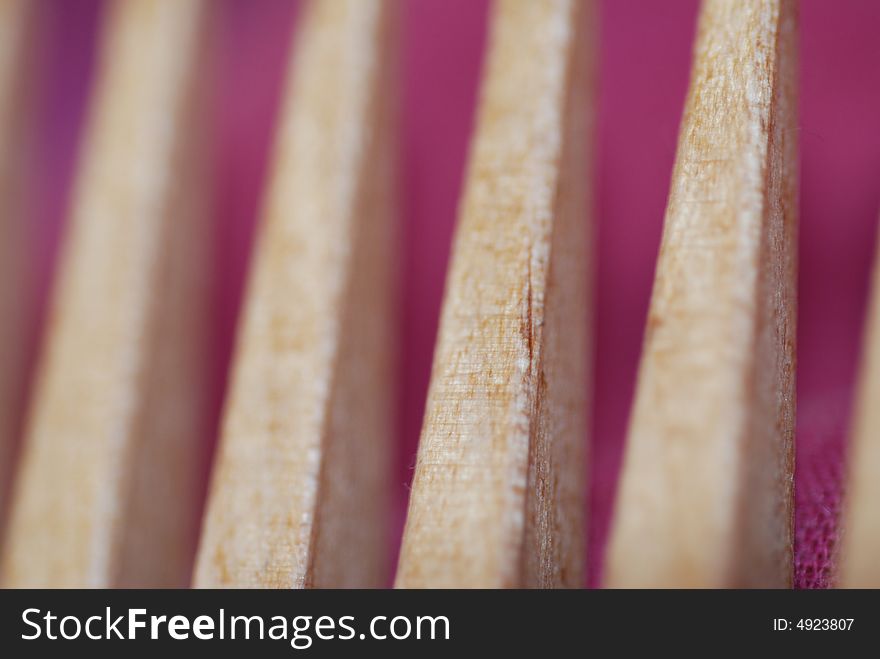 A close-up of a wooden comb, short depth of field. A close-up of a wooden comb, short depth of field