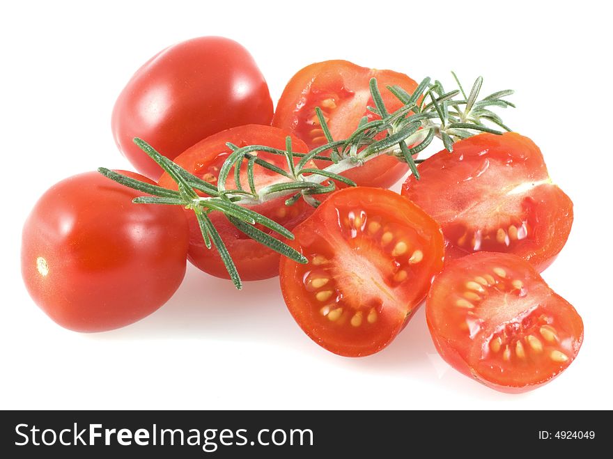 Cherry tomatoes and a thyme branch on a white background. Cherry tomatoes and a thyme branch on a white background.