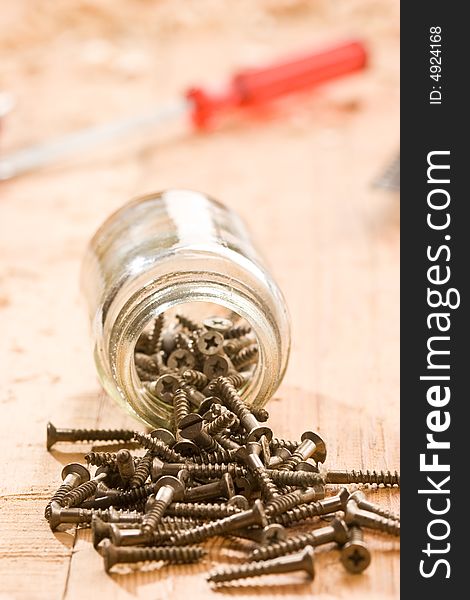 Tools series: some metal screw on the wooden plank. Tools series: some metal screw on the wooden plank