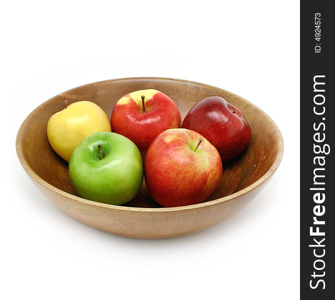 Fresh apples in a wooden bowl isolated on white. Fresh apples in a wooden bowl isolated on white