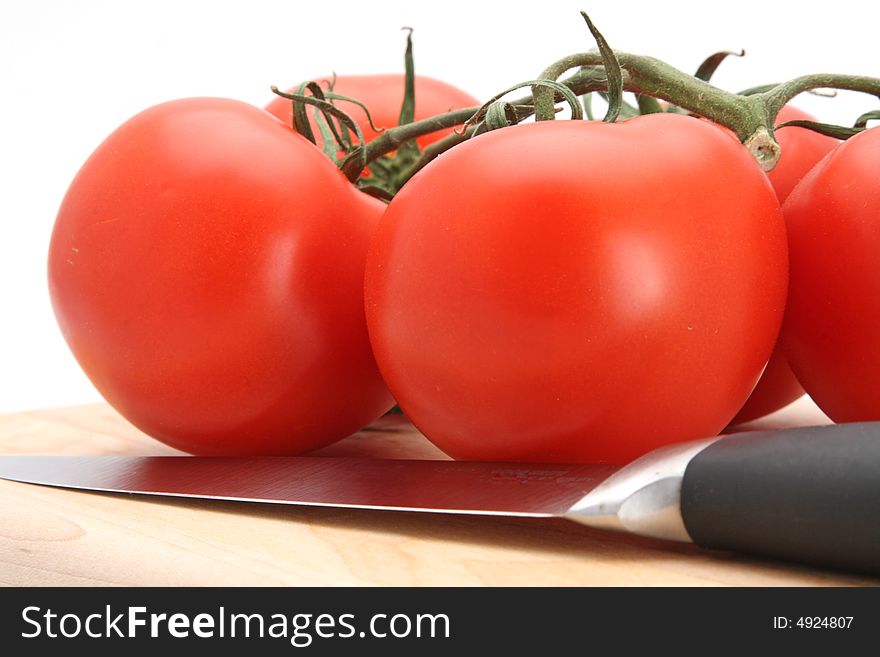 Fresh picked red vine tomatoes white background