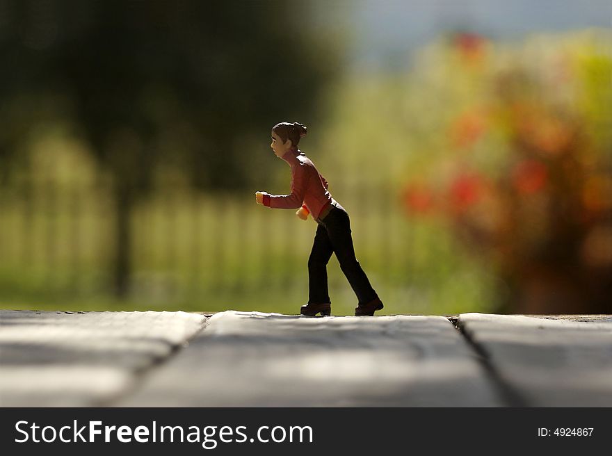 Woman walking along edge, miniature