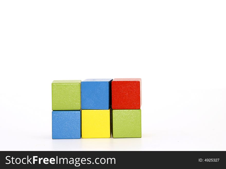 Six colored children's building blocks red green yellow blue. Six colored children's building blocks red green yellow blue