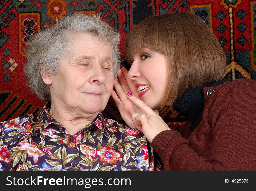Grandmother and granddaughter gossiping