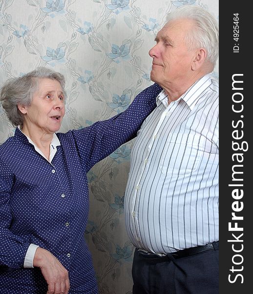 Happy old couple talking at home