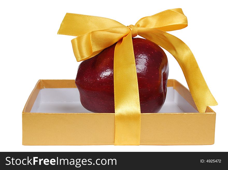 Red apple in box with yellow tape like gift. isolated on white