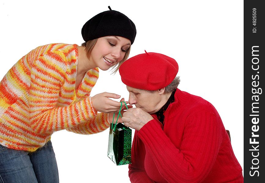 Grandmother and granddaughter with present. isolated on white