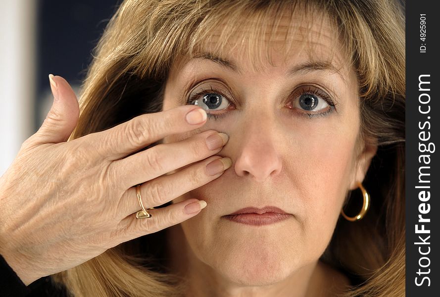 Woman Inserting Contact Lens in Eye