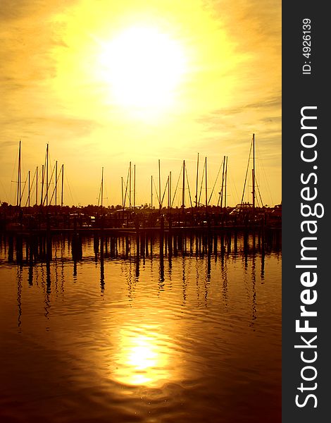 Sailboats docked in the harbor at dusk in Florida. Sailboats docked in the harbor at dusk in Florida