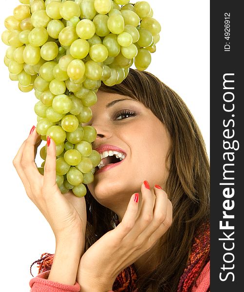 Young woman eating grapes. Isolated on white.