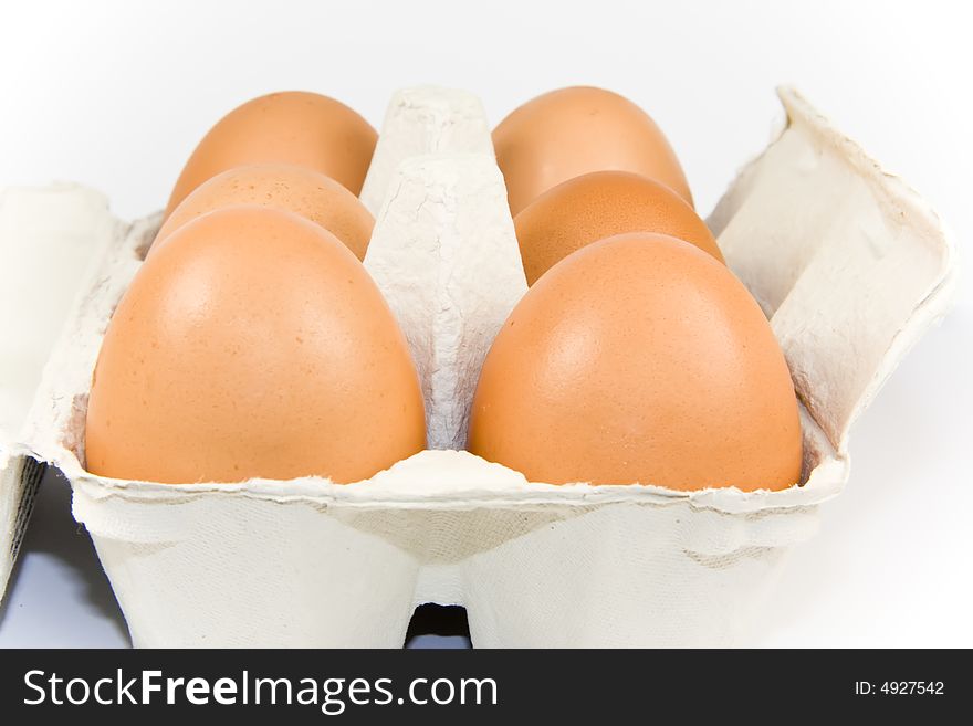 Six eggs in carton isolated on white