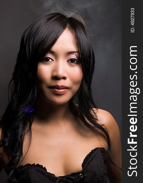 Portrait of a beautiful asian american in black background. Portrait of a beautiful asian american in black background.