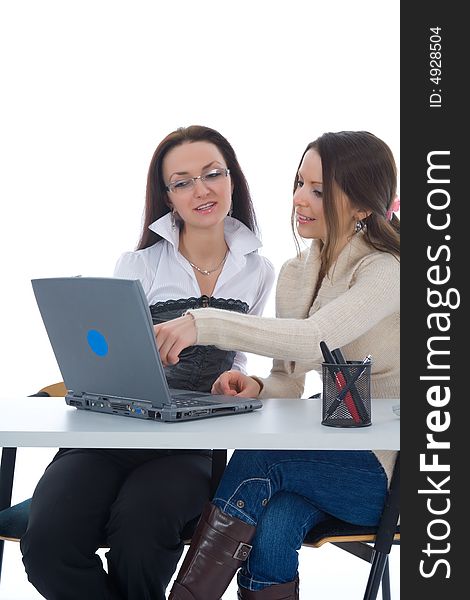 Two business women work with laptop on white