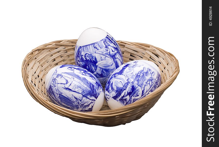 Easter eggs in a basket on the isolated white background