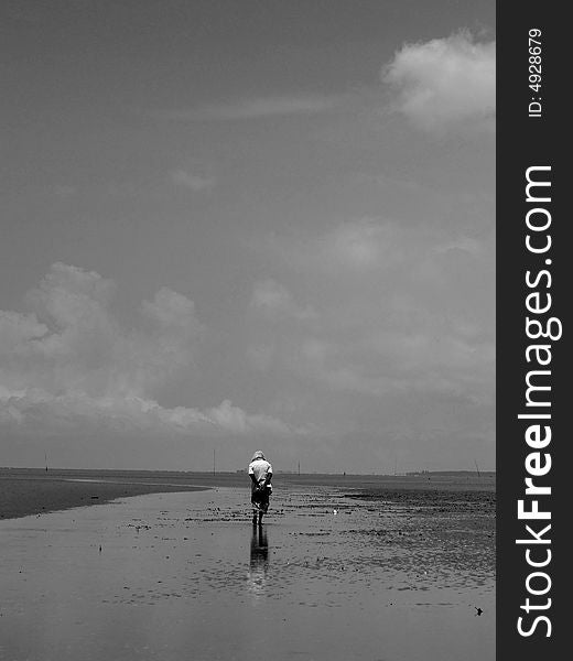 A old man walking along the Morib Beach, west coast Malysia. A old man walking along the Morib Beach, west coast Malysia.