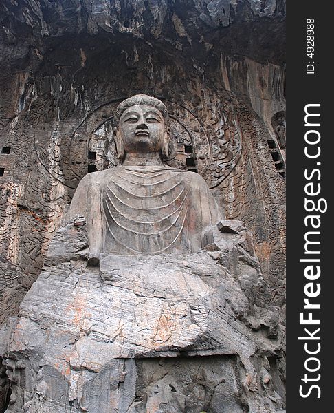 The stone statue of Budda chiseled out of the mountain stone,Longmen Grottoes,Luoyang,Henan,China,Asia. The stone statue of Budda chiseled out of the mountain stone,Longmen Grottoes,Luoyang,Henan,China,Asia.