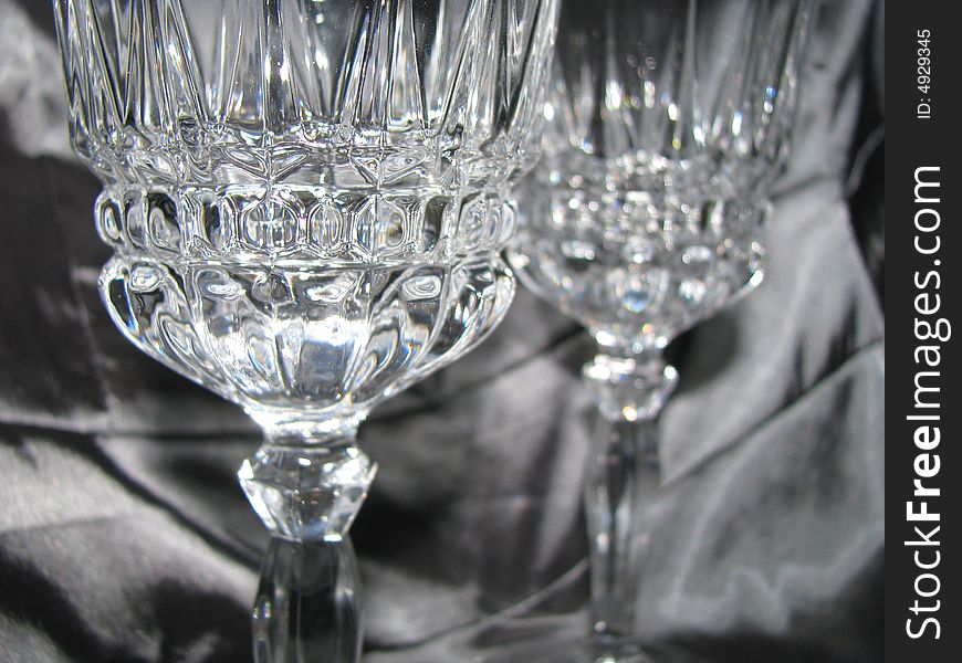 Two crystal glasses caught in the light. Two crystal glasses caught in the light.
