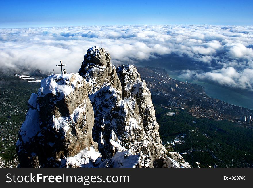 Winter view from top of mountain on the sea, on a cloud and on small city. Winter view from top of mountain on the sea, on a cloud and on small city