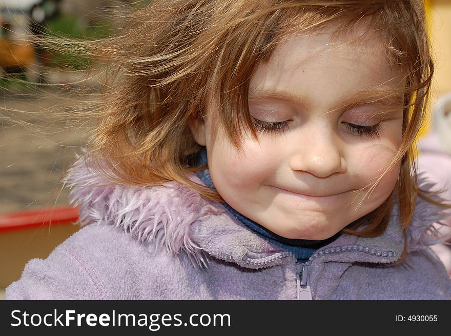 Funny little girl with hair flying in wind. Funny little girl with hair flying in wind