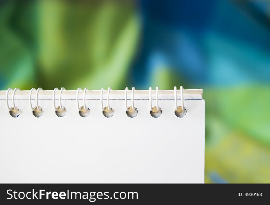 Blank notepad on the colored background