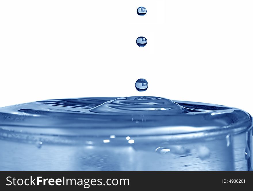 Isolated blue drops are falling down and impact with liquid surface. Isolated blue drops are falling down and impact with liquid surface