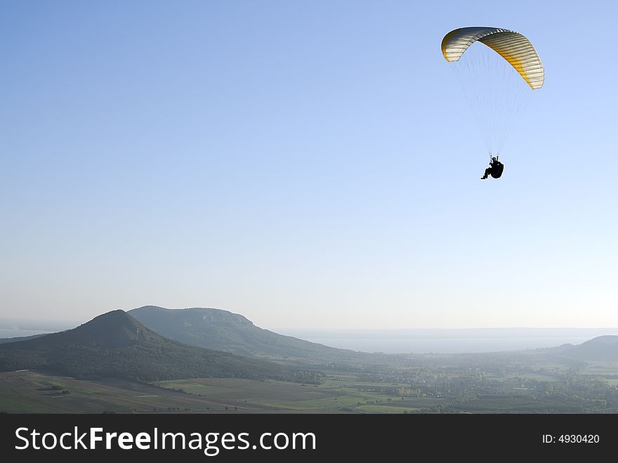 Paraglider flying over the Hungarian countryside